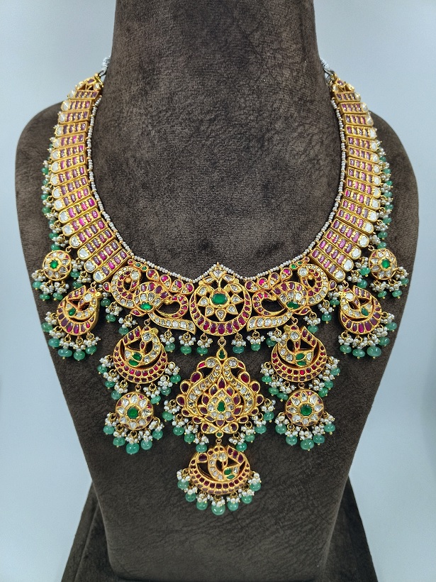 Traditional gold necklace with rubies, emeralds and pearls
